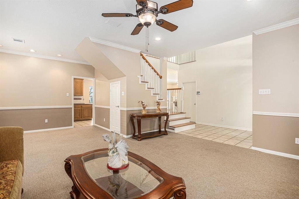 Standing in the corner of the formal living room, looking toward entry, you can see the formal dining, a peek a boo of the kitchen, and the grand entry. High ceilings too!