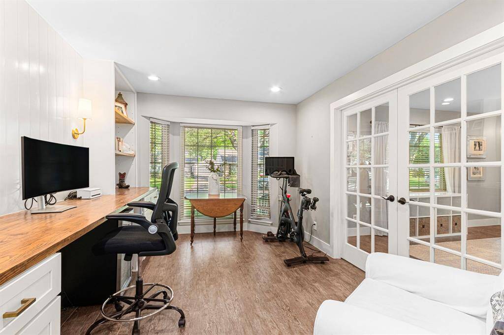 FLEX SPACE- Currently used as an office with great built-ins and on trend light sconces. Glass French doors continue the open concept of the home.