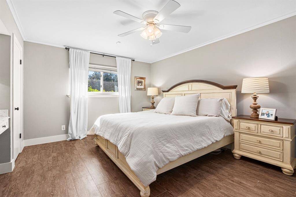 PRIMARY BEDROOM - Oversized primary bedrooms suite with bright windows, beautiful floors and ceiling fan.