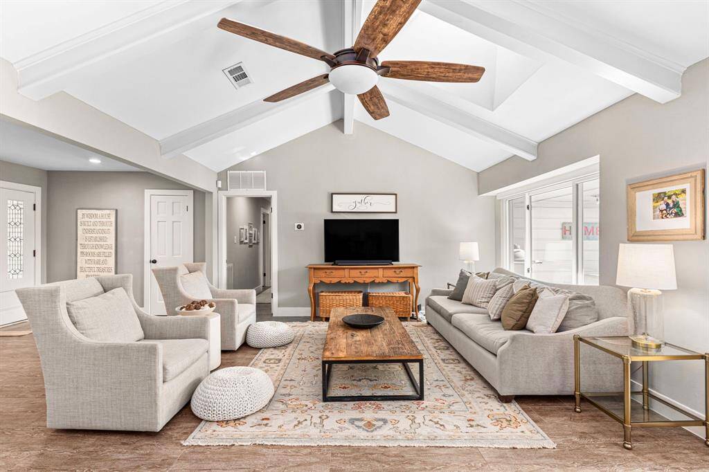 LIVING ROOM - Vaulted ceilings and large bright windows! This open concept home is great for entertaining. Wood tile through out the entire home.