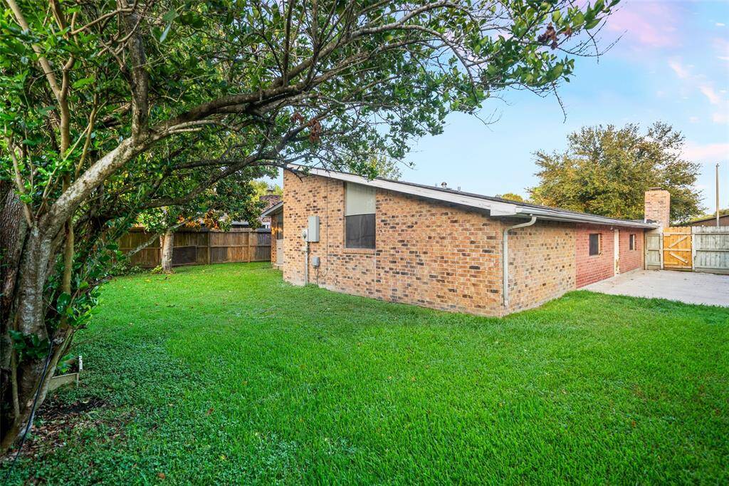 View from corner of spacious backyard! Perfect for bbqs