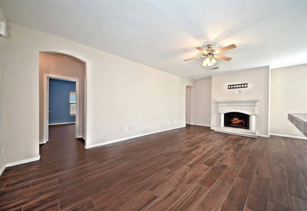 The grand family room features high ceilings and is pre-wired for surround sound, offering a spacious and comfortable setting for relaxing or entertaining.