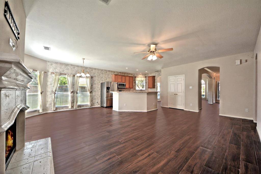 The open-concept kitchen boasts French doors, a walk-in pantry, and views of the casual dining and family room—perfect for both everyday living and hosting guests.