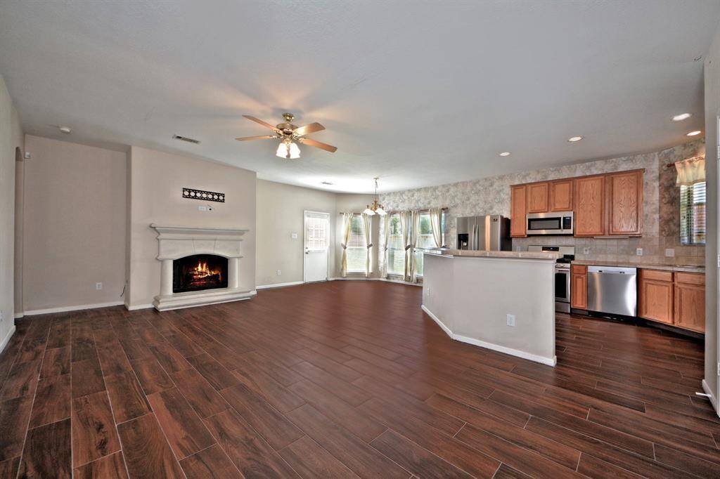 The family room includes an upgraded cast stone fireplace and flows easily into the casual dining area and gourmet kitchen, creating one cohesive and inviting space.