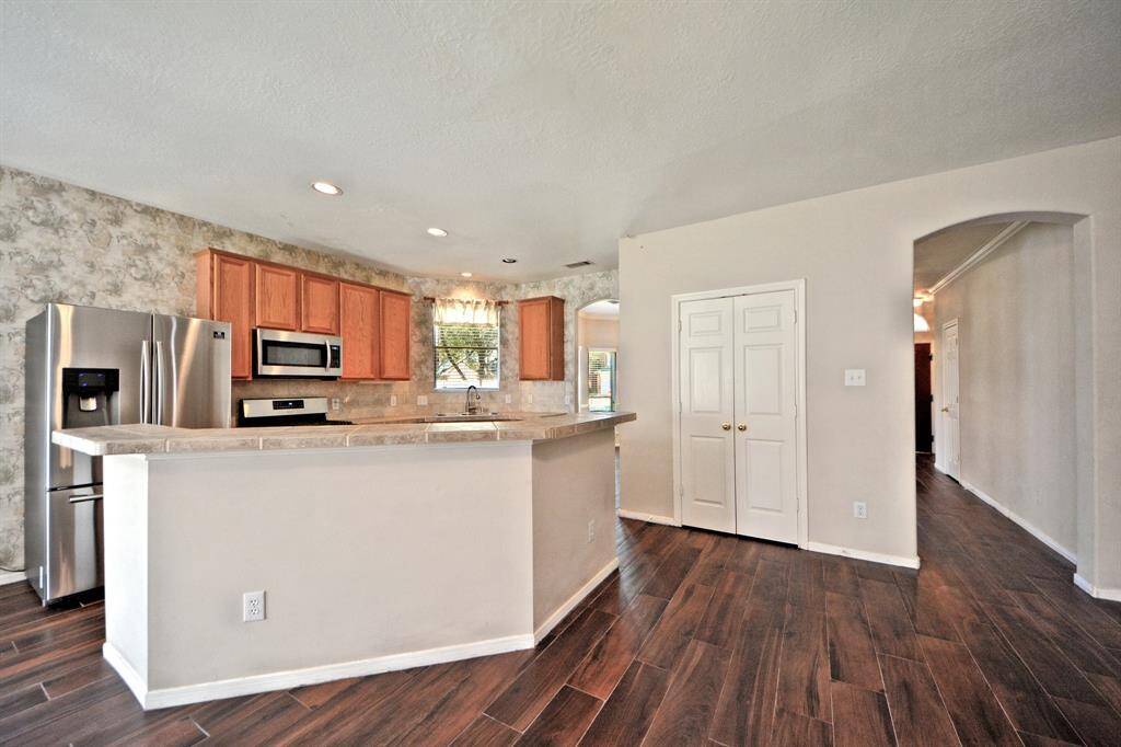 The eat-in island offers a generous workspace with upgraded counters, ideal for both quick meals and preparing your favorite recipes.
