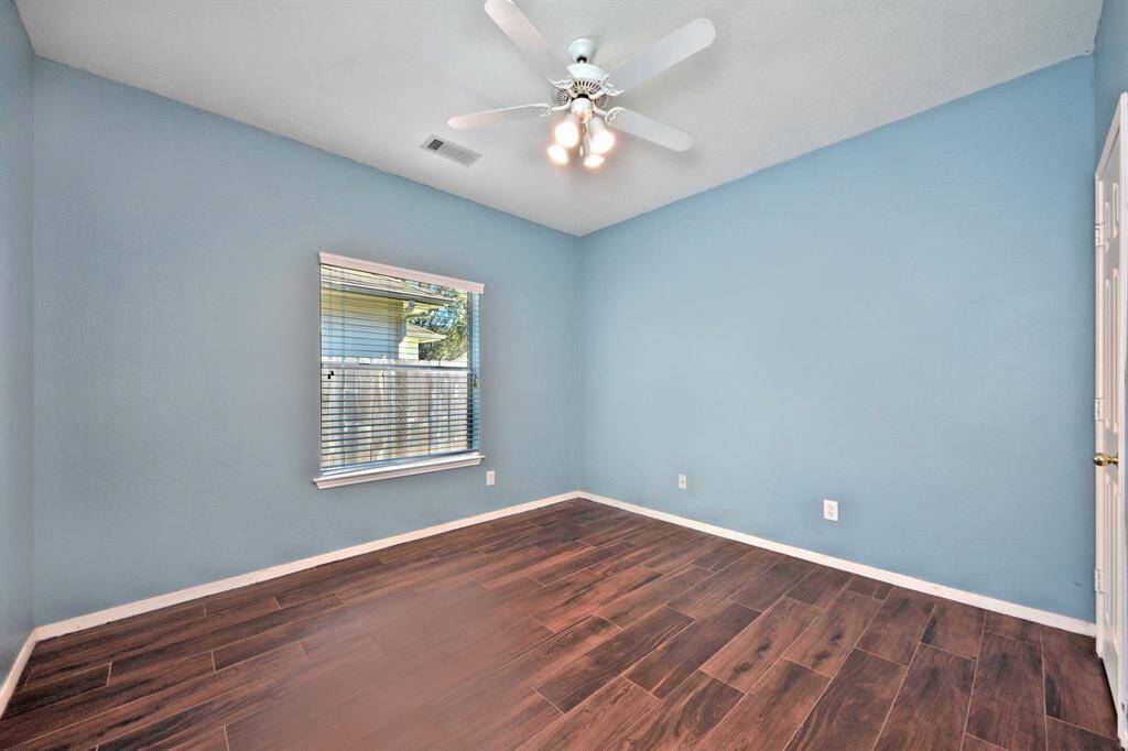 Guest bedrooms include walk-in closets and upgraded wood tile floors—an ideal option for allergy-sensitive buyers seeking a carpet-free home.