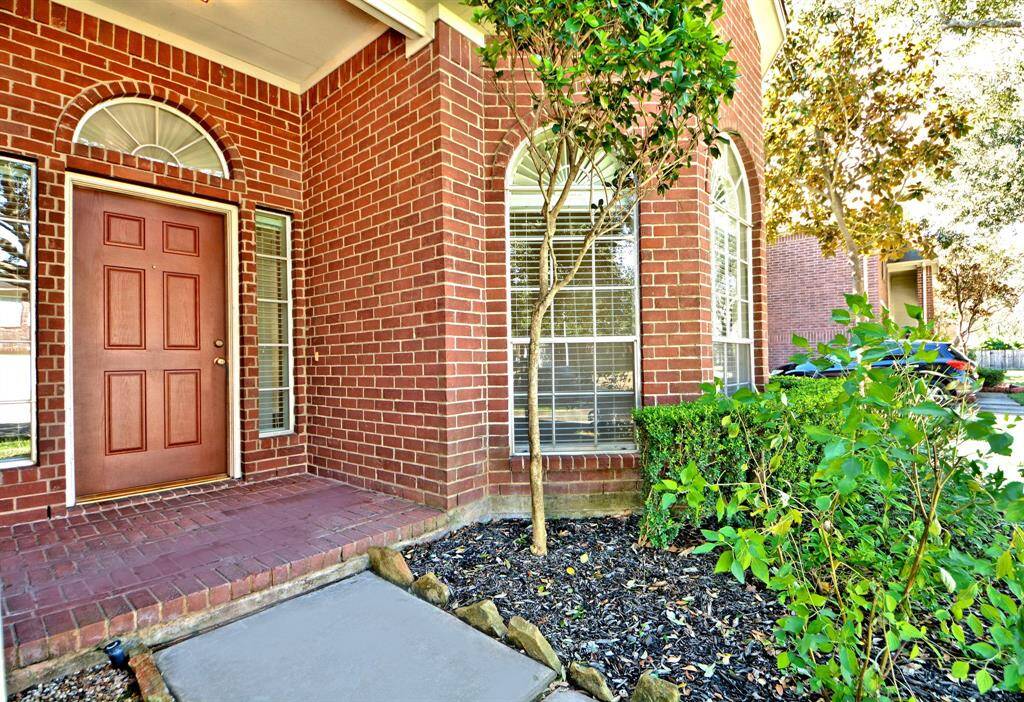 The front entry includes a classic brick elevation with a well-maintained appearance, charming front porch, and neatly manicured landscaping that creates a warm and welcoming first impression.
