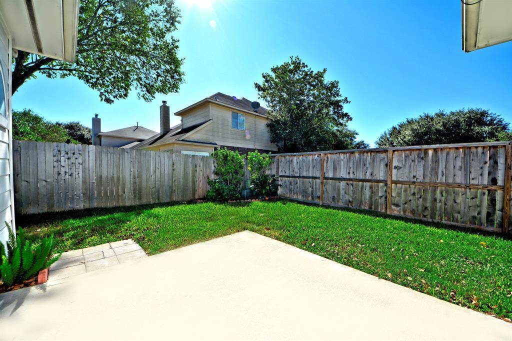 The fully fenced backyard provides a secure and private outdoor space with room for kids, pets, or weekend entertaining.
