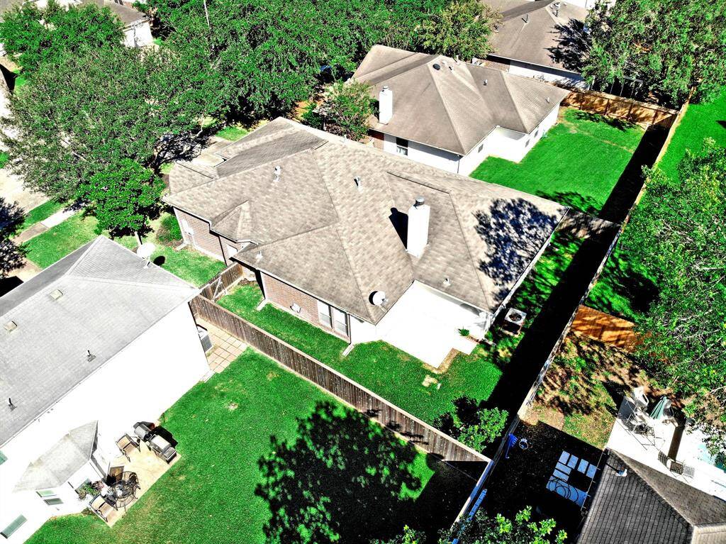 An aerial view of the property showcases the beautifully maintained lot and the charming neighborhood setting—truly a place to call home.