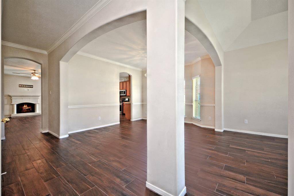 The grand entry showcases art niches, arched doorways, and beautiful tile wood floors throughout—combining stylish design with easy maintenance.