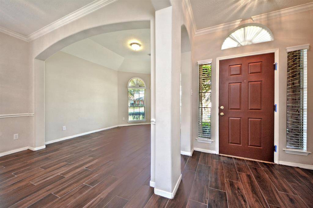 The formal dining room flows into the formal living area, creating an open layout that’s ideal for entertaining family and friends in a comfortable and inviting space.