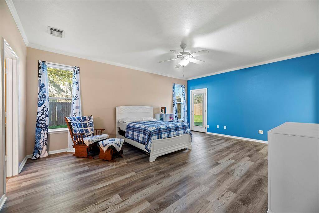 This very spacious primary bedroom has all new windows (like the entire house), and a private door to the back patio and pool.