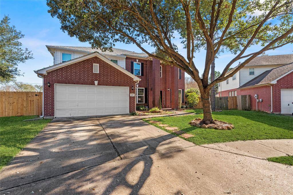 The mature tree adds to the curb appeal of this well appointed house and massive lot.