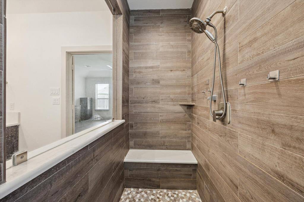 Beautiful custom primary bathroom. Large quartz countertops with dual sinks.