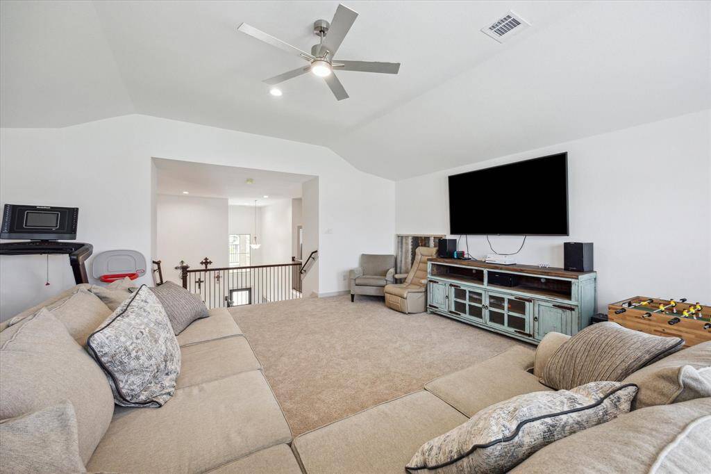 This Grand gameroom with high vaulted ceilings provide many options during game night.