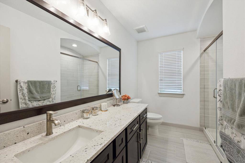 Jack and Jill bathroom with separate privacy doors.