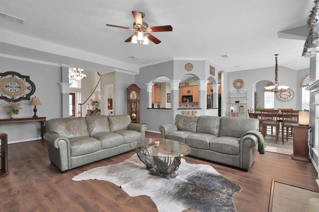 The family room has crown molding and the floors have been updated with luxury vinyl plank.