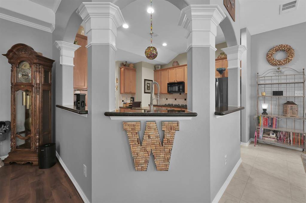 The kitchen and breakfast are open to the family room. The walls and openings are accented with crown molding.