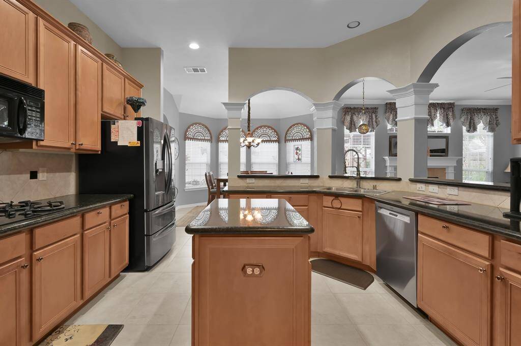 Another view of the spacious kitchen open to the breakfast and family areas.  Great view of the backyard from this part of the home.