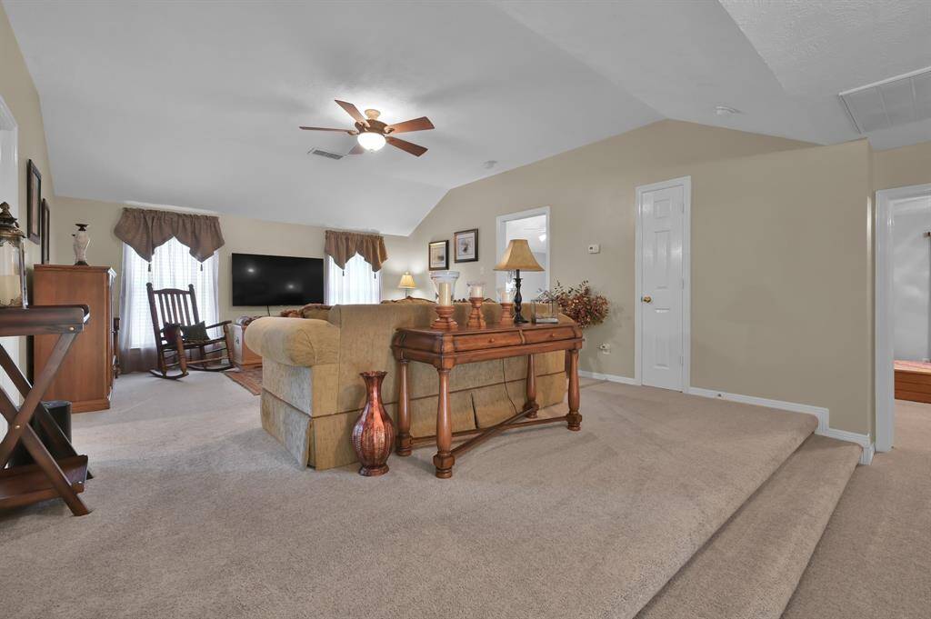 The large game room has vaulted ceiling and a ceiling fan.  Perfect for game day or movie night!