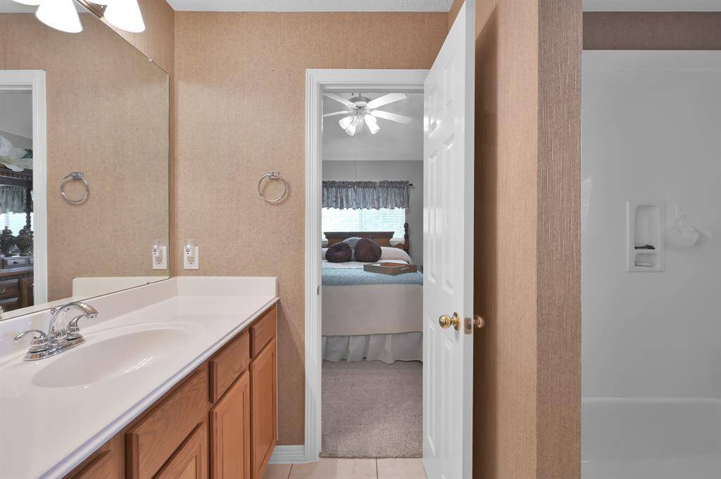 One of the secondary bathrooms with a spacious counter top and plenty of drawers and cabinets.