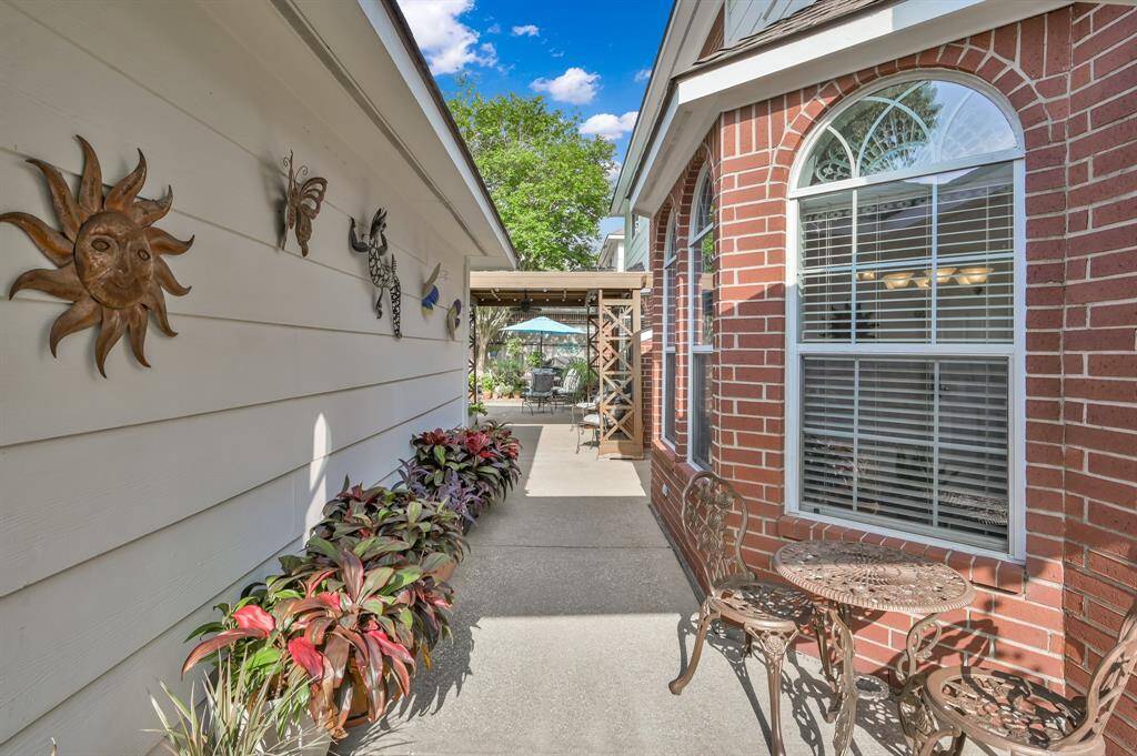 The walkway in between the backdoor and garage leads to the backyard and pool.