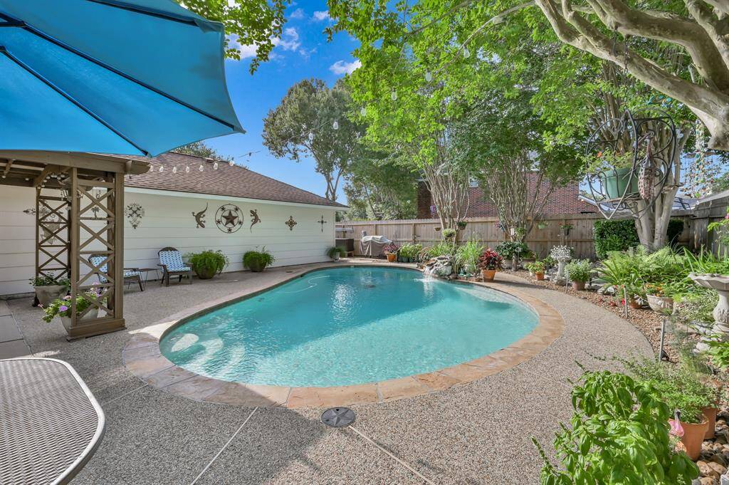 Check out this beautiful backyard and pool!  What a great space to entertain family and friends!
