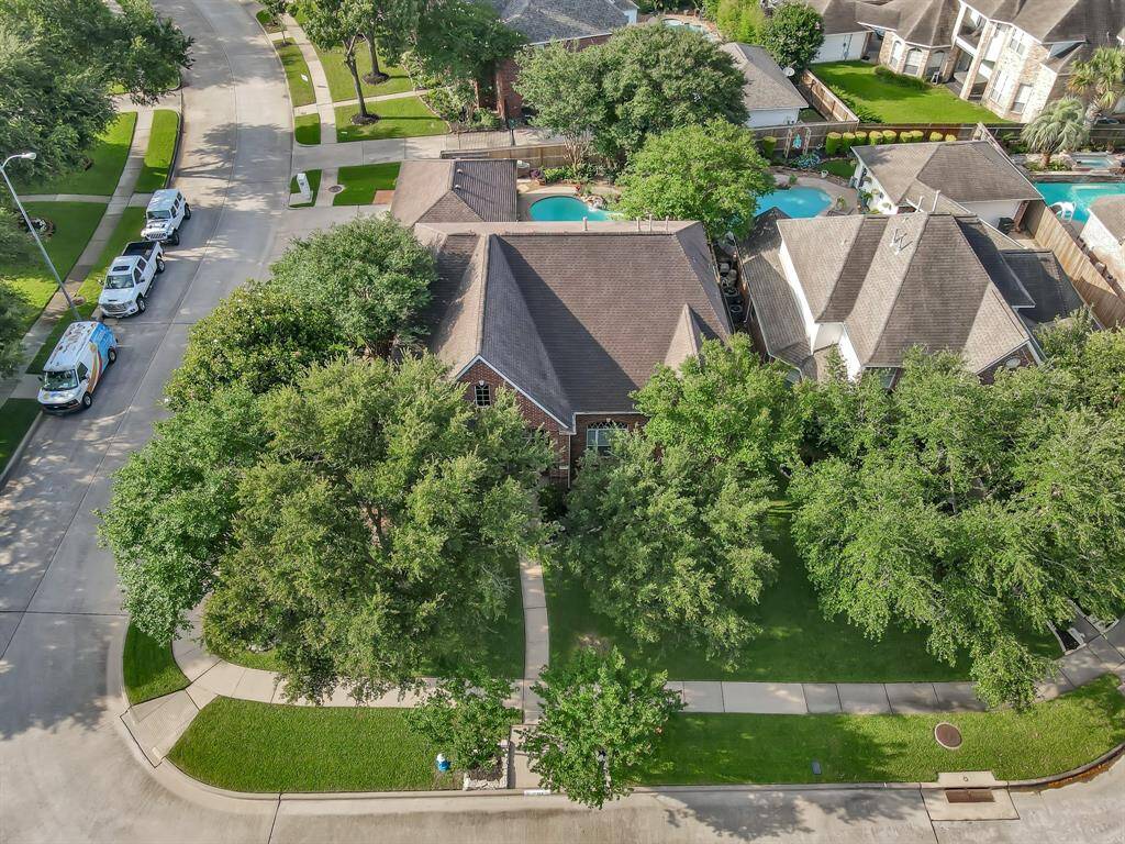 An overhead view of the corner lot with lots of trees.