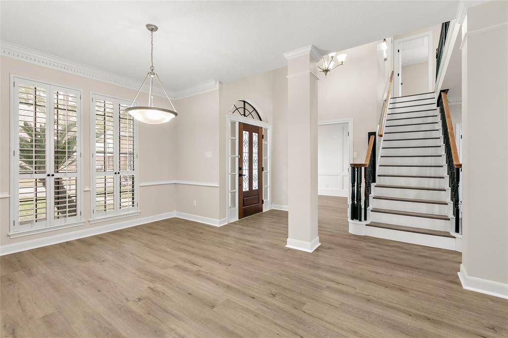 The formal dining room takes in a view of the landscaped front yard.