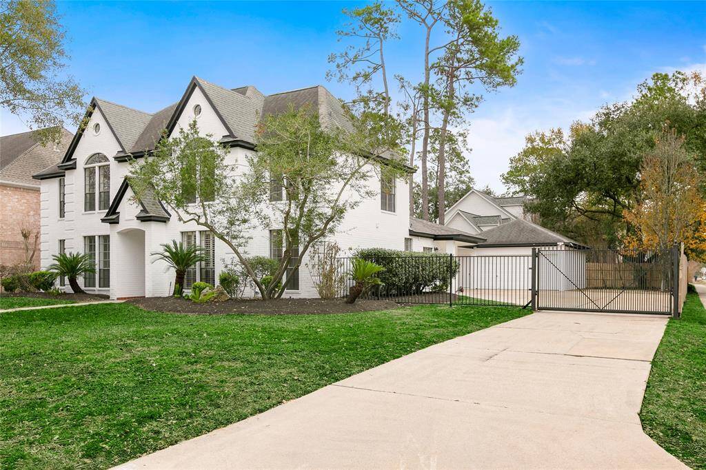 Complete with a privacy gate & spacious driveway leading to a two-car, detached garage.