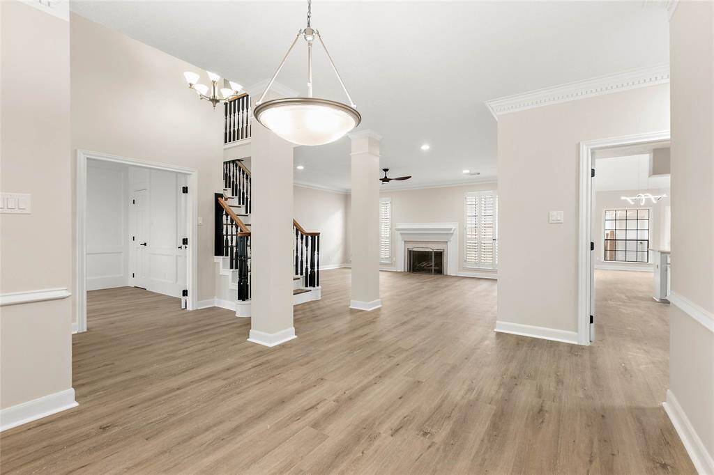 A view from the formal dining room highlights the luxurious vinyl plank flooring that extends throughout the home. Wonderful open-concept floorplan is ideal for entertaining.