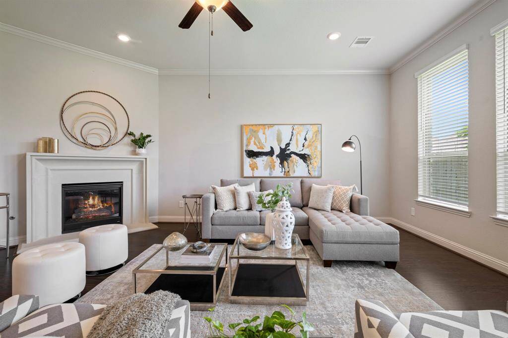 This inviting living room features a cozy fireplace, and large windows that provide ample natural light.