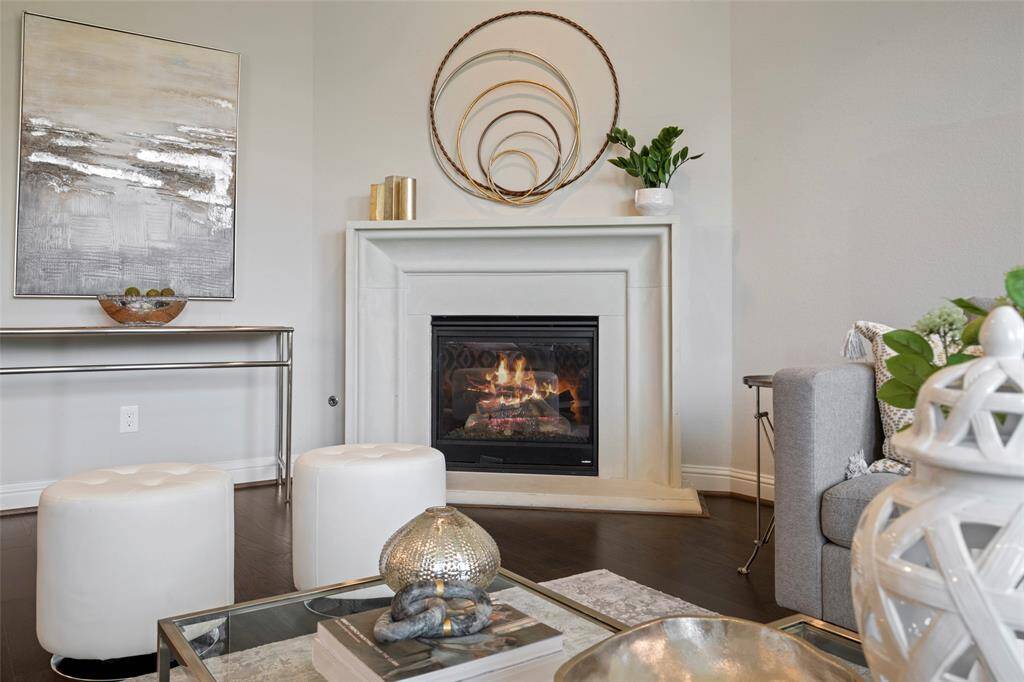 This inviting living room features a cozy fireplace, and large windows that provide ample natural light.