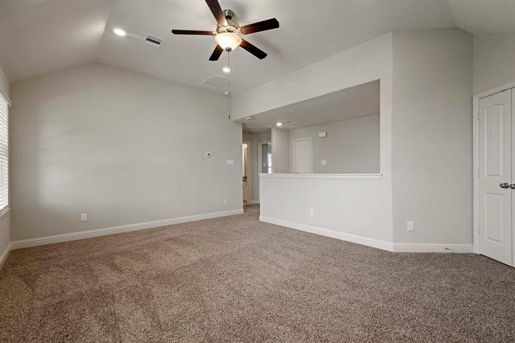 In the upstairs you will find ample space. This flex room features neutral walls and carpet, a ceiling fan with lights, and can be used in different ways.