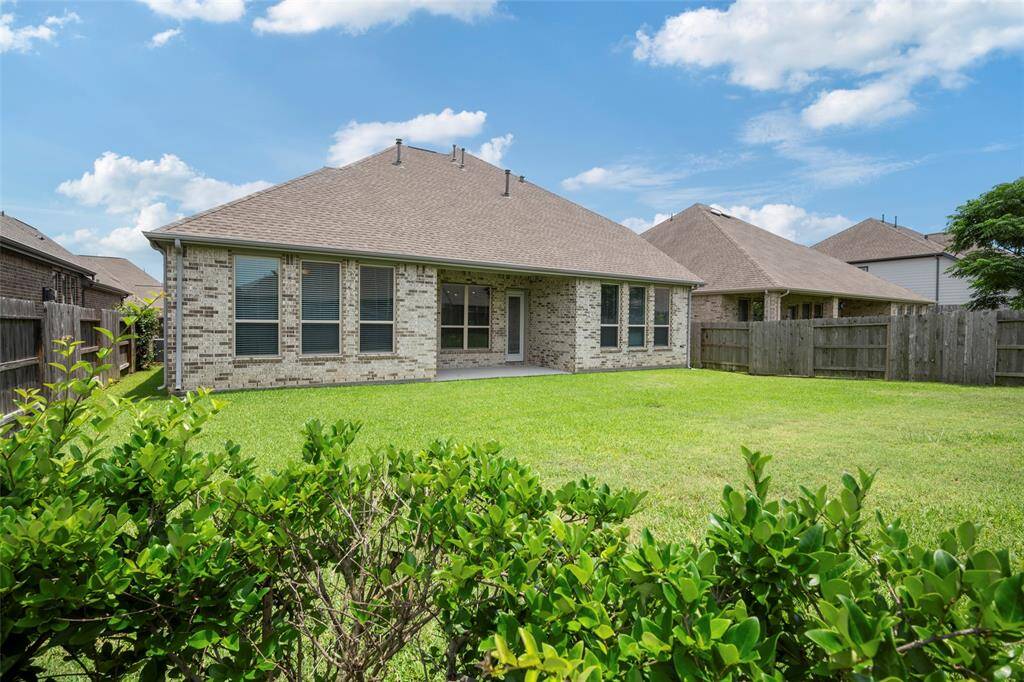 Charming brick home with a spacious fenced backyard, ideal for privacy and outdoor activities.