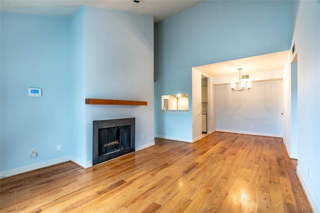 Welcome Home To Unit 106!  Wood Floors Throughout and Wood-Burning Fireplace
