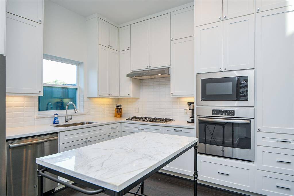 Another view of the kitchen with modern applicances, contemporary hardware and lots of room to prepare great meals.