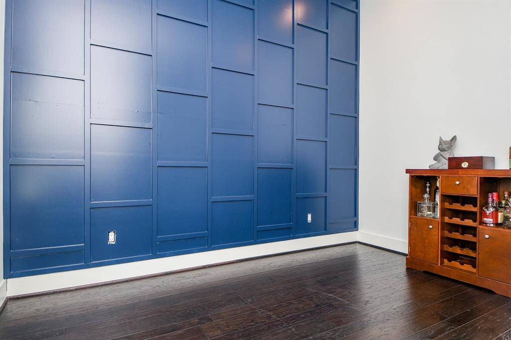 A custom-made contemporary accent wall in the downstairs bedroom gives that "wow" effect.  This bedroom has a full bath and a great view of the courtyard.