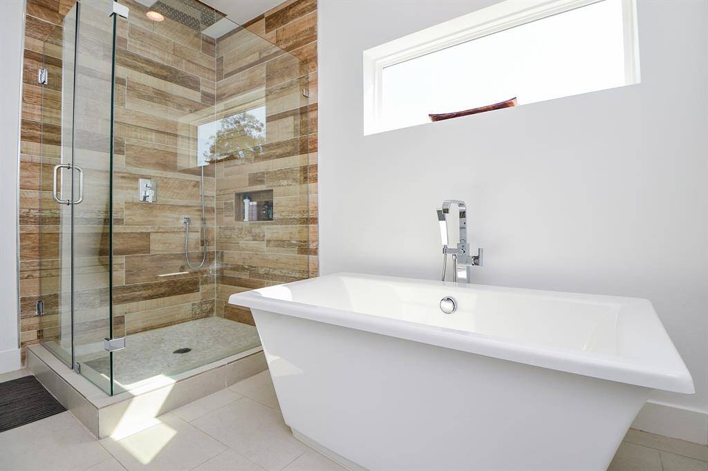 The ensuite master bath with a large beautiful shower and freestanding tub.