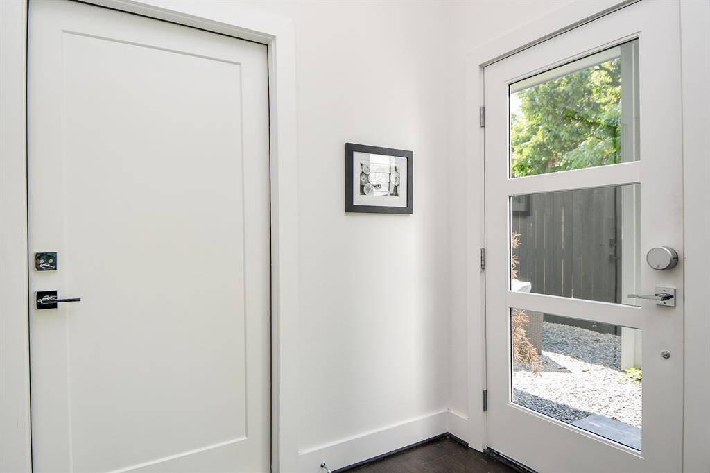 The contemporary front door off the private entry courtyard allows plenty of daylight yet total privacy.