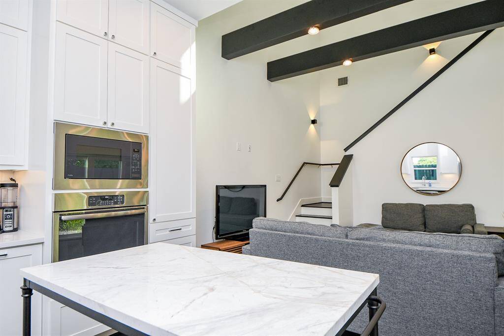 The kitchen has built ins and a large free-standing marble island.