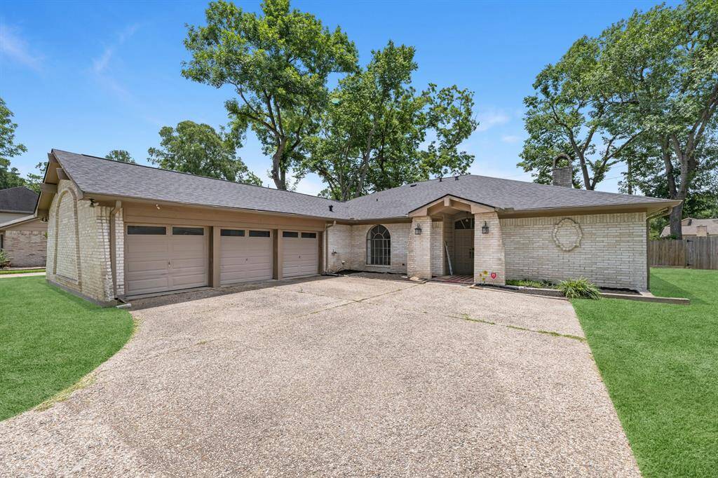 Clean and classic front view with spacious driveway.