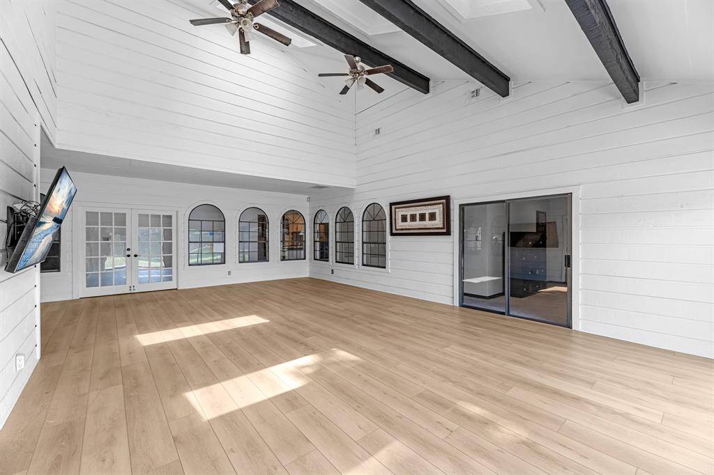 Flexible layout with view into other rooms through arched windows.