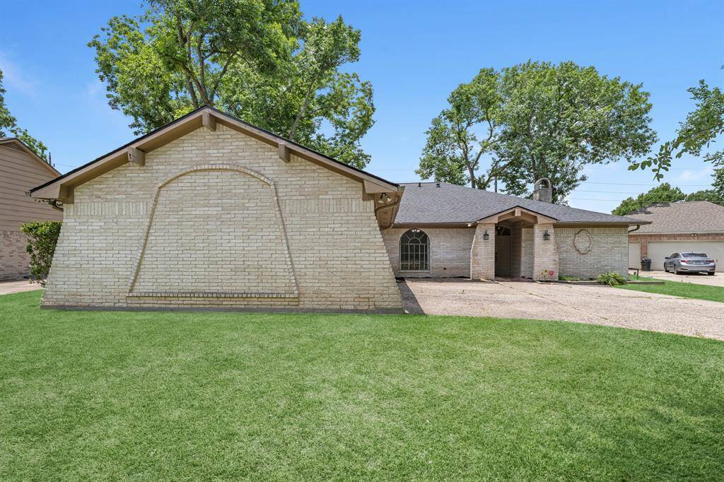 Side view shows unique brick detail and extra yard space.