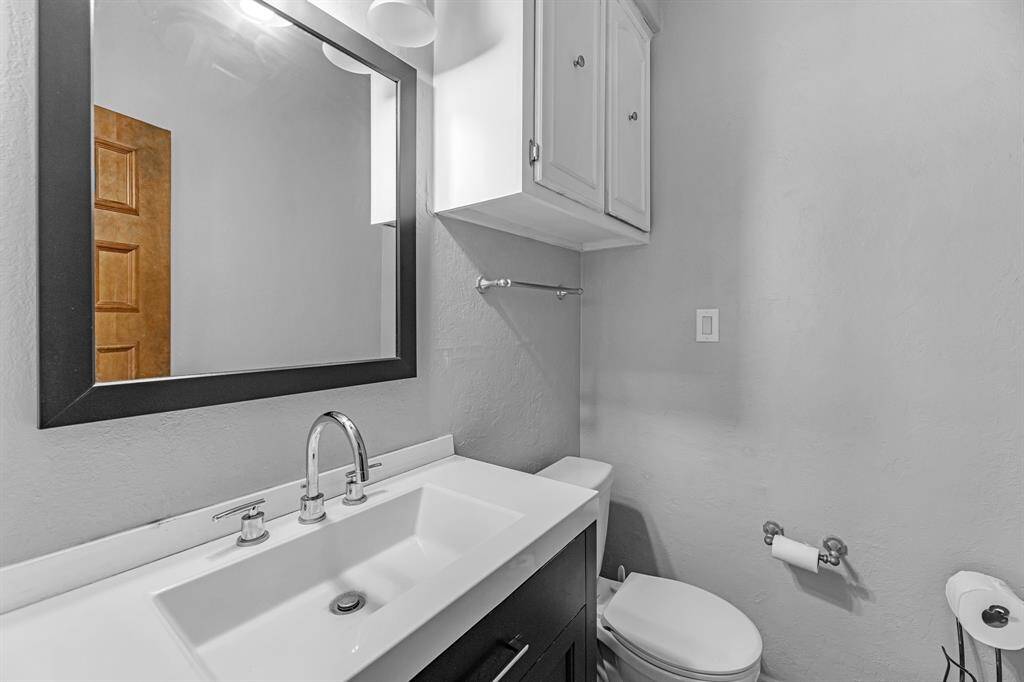 Updated half bath with modern vanity and framed mirror.