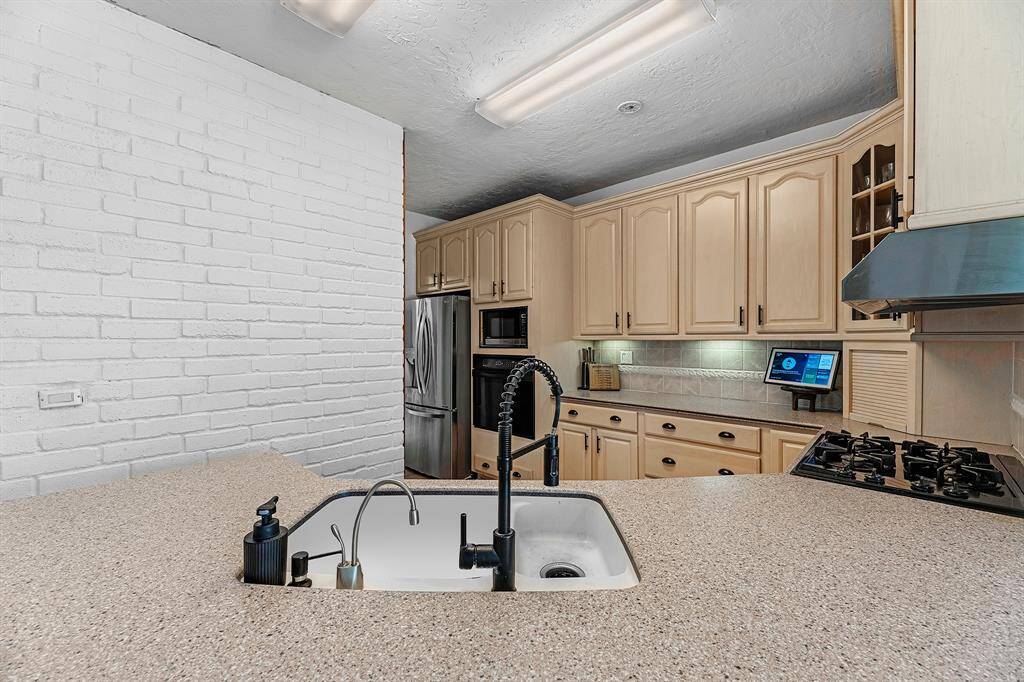 Functional kitchen layout with deep sink and sleek faucet.