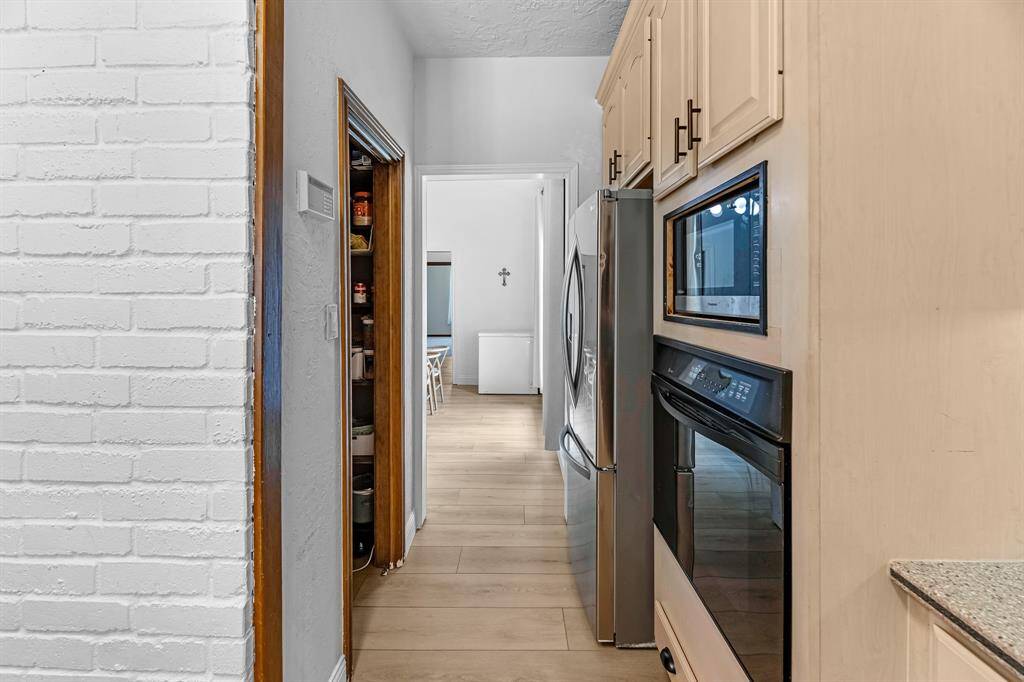 Walk-through pantry space leading to the dining area and laundry.