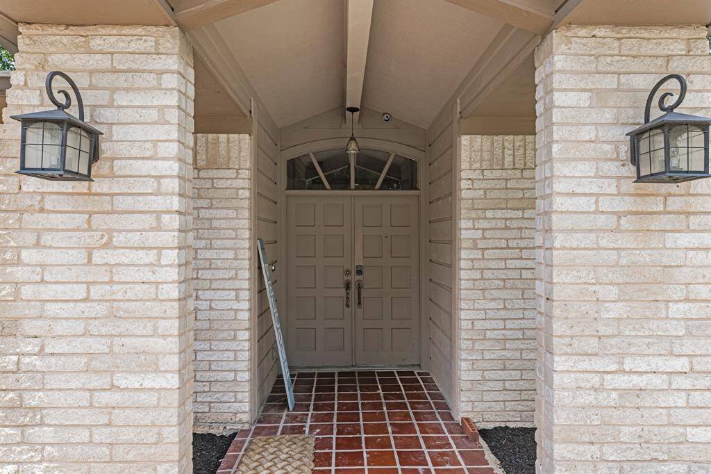 Covered front entry with charming brick columns.