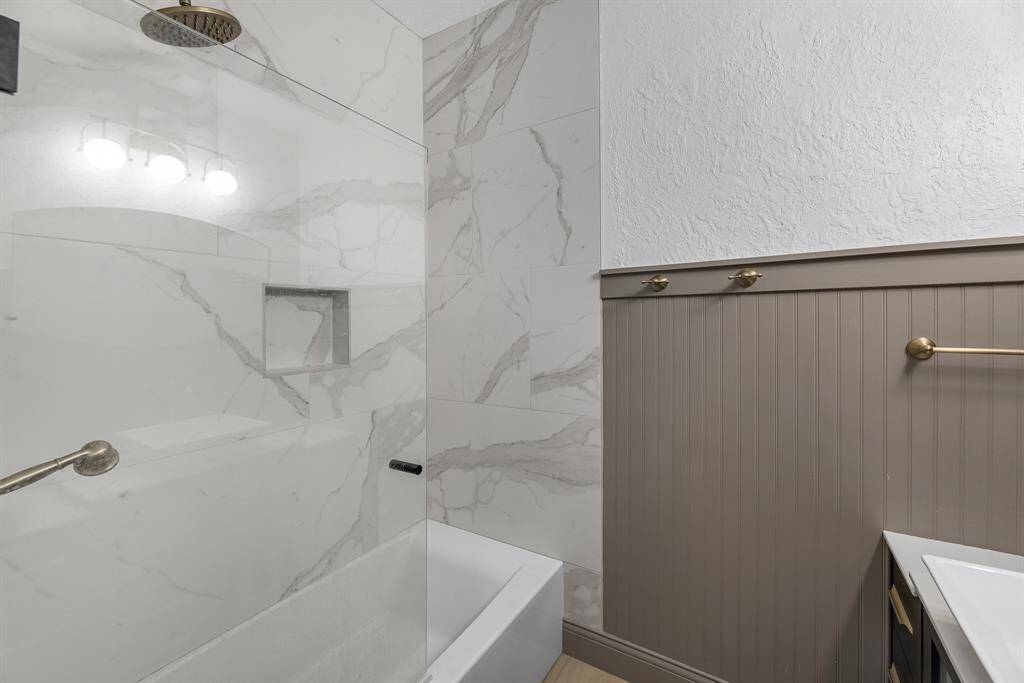 Beautiful tiled shower with built-in niche and rain head.