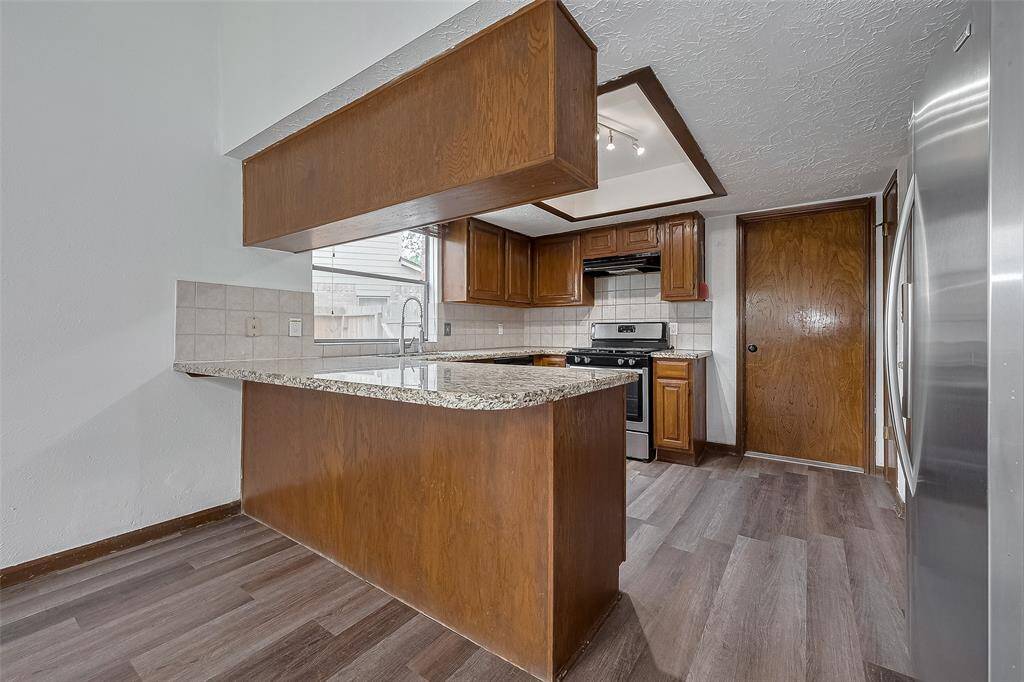 The peninsula-style breakfast bar adds extra prep space and casual seating in the heart of the kitchen.